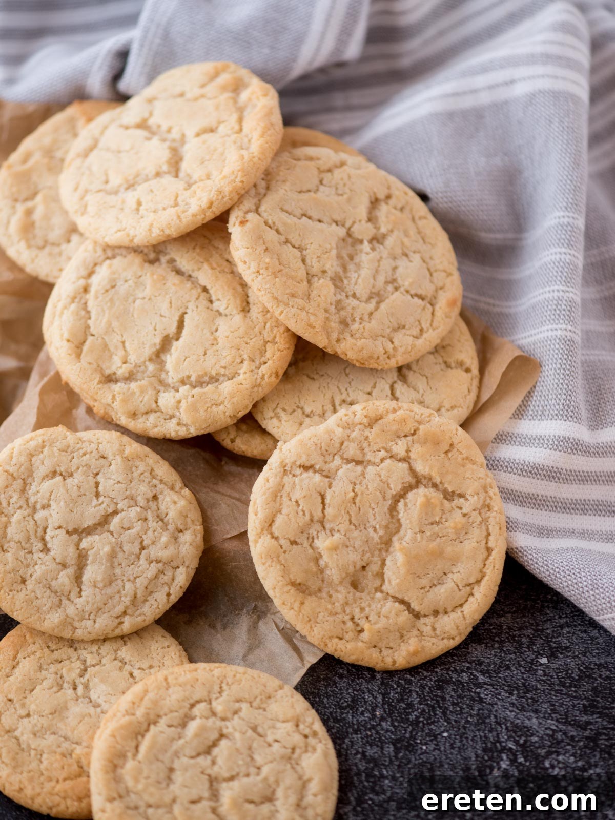 Close-up stack of several golden-brown condensed milk cookies, showcasing their soft texture and rounded shape