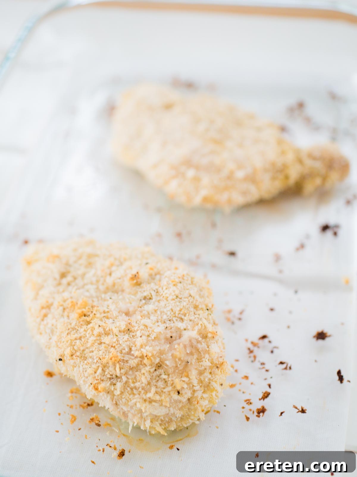 Crispy panko-crusted chicken breasts baked in a dish, golden brown and perfectly cooked.