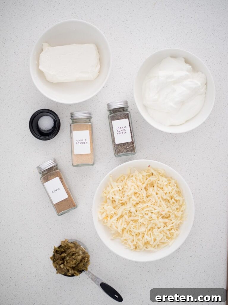All the fresh ingredients required to prepare a batch of delectable Smoked Queso Blanco, neatly arranged on a counter before mixing.