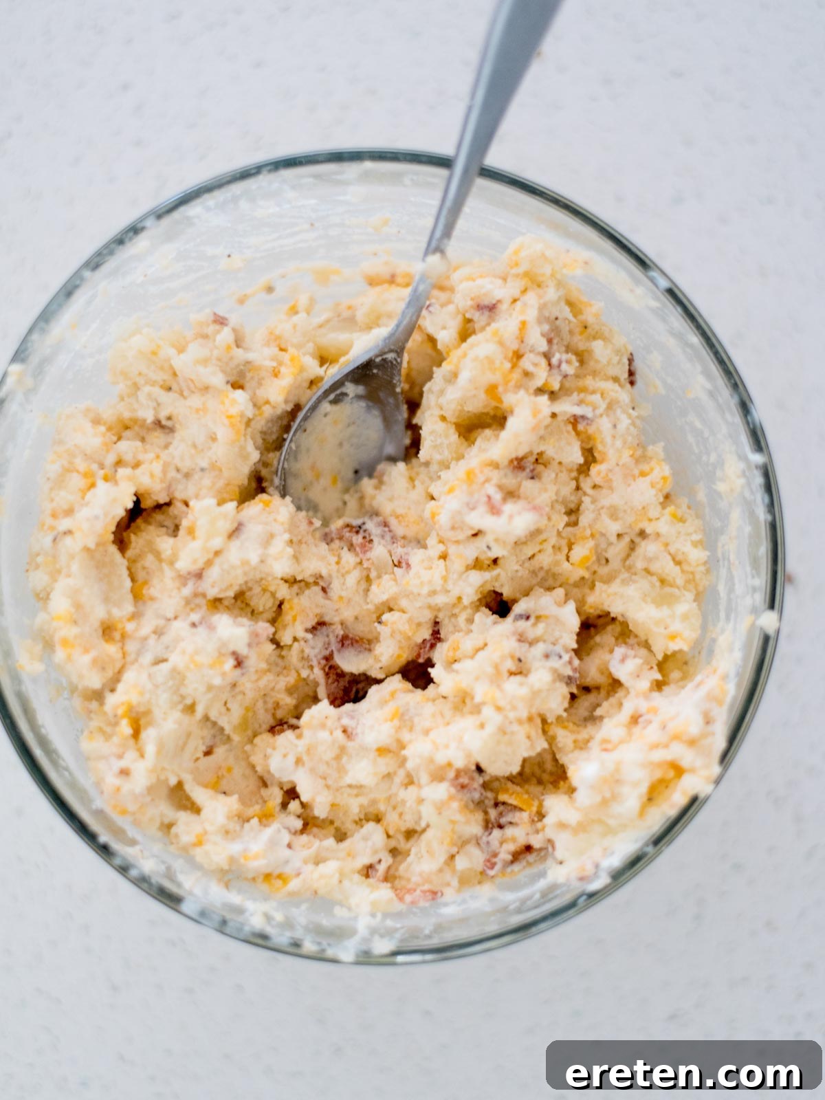 Mixing bowl with the potato mixture for twice baked potatoes ready to use.
