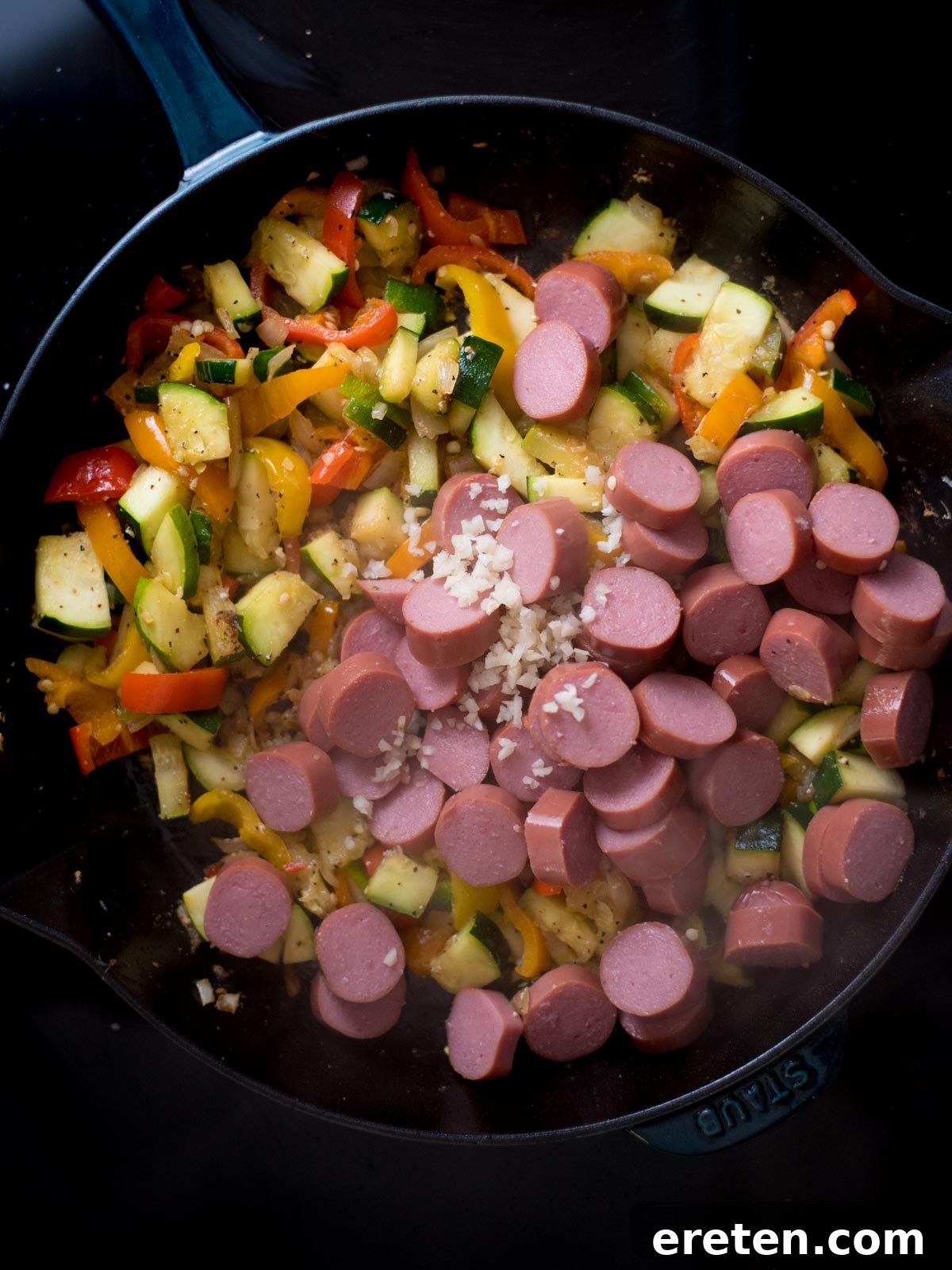Cajun Fire Skillet with Shrimp and Sausage 6 Veggies and sausage added to a skillet with diced garlic.