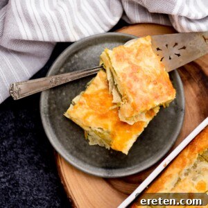 Two slices of chile relleno on a plate with a pie server resting on the plate.
