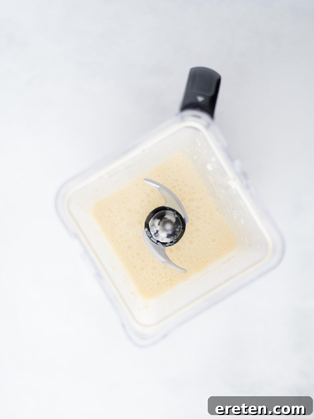 Blender showing the egg mixture combined, a smooth and fluffy texture ready for the casserole.
