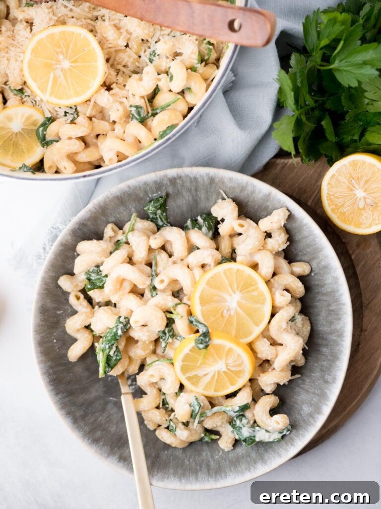 Top view of a bowl with lemon ricotta pasta and 2 lemon round garnishes in the middle.
