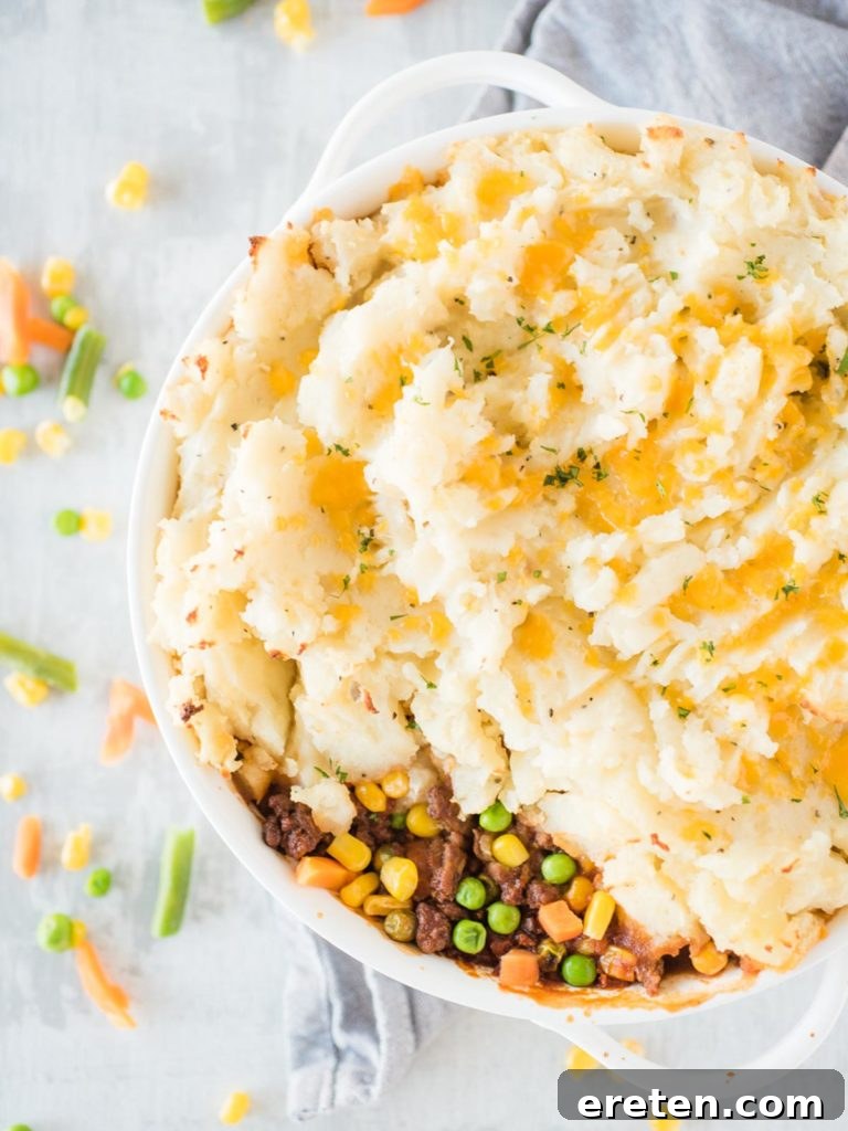 Hearty cottage pie baked to golden perfection in a white baking dish, ready to be served
