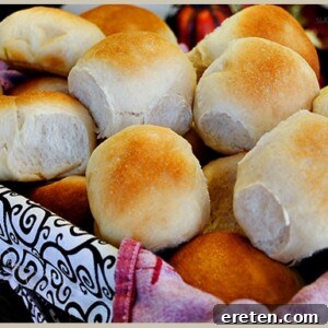 Golden brown honey dinner rolls, soft and fluffy, ready to be served.