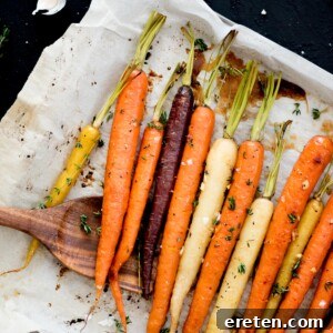 Oven-roasted carrots seasoned with brown sugar and garlic on a baking sheet, ready to serve.