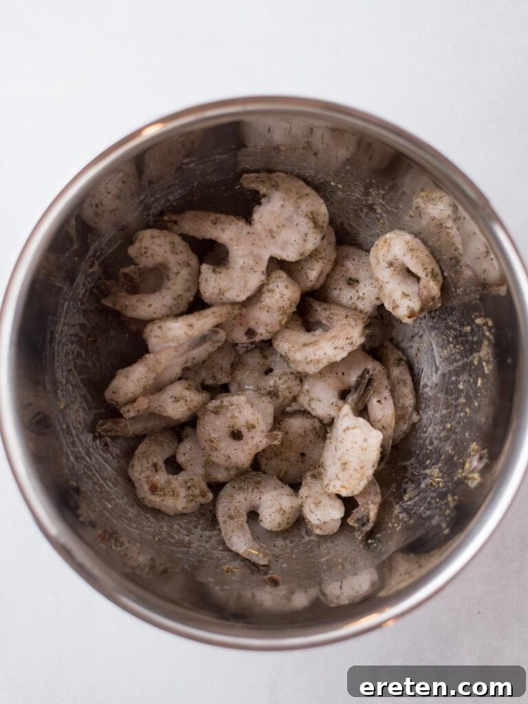 Crispy Air Fryer Frozen Shrimp 5 Frozen shrimp fully coated with oil and seasoning, ready for the air fryer.