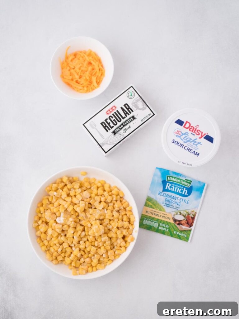 All the fresh ingredients laid out on a wooden board, ready to be combined for a delicious homemade corn dip with cream cheese.