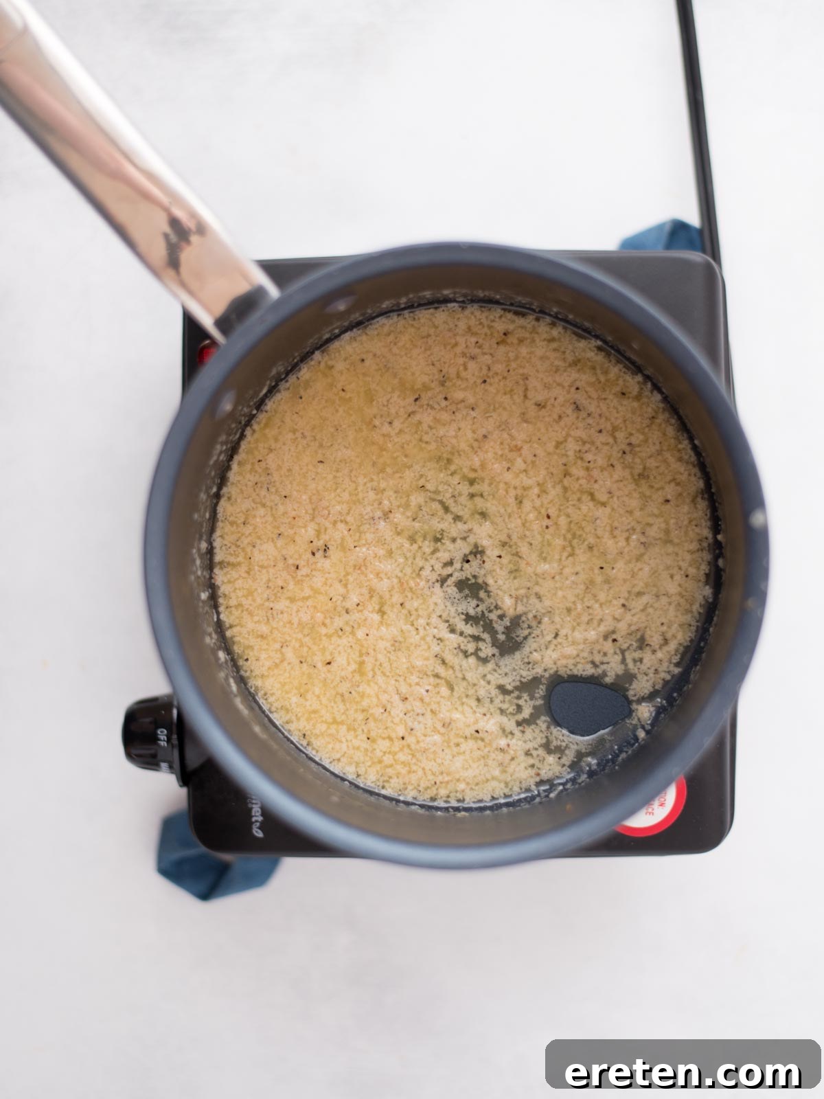 Air-Fried Golden Garlic Parmesan Wings 11 Smooth and creamy garlic parmesan sauce in a saucepan, ready to be tossed with wings