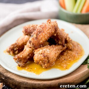 garlic parmesan chicken wings stacked on a light blue plate