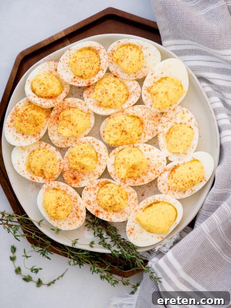 Top view of a platter filled with paprika sprinkled deviled eggs.