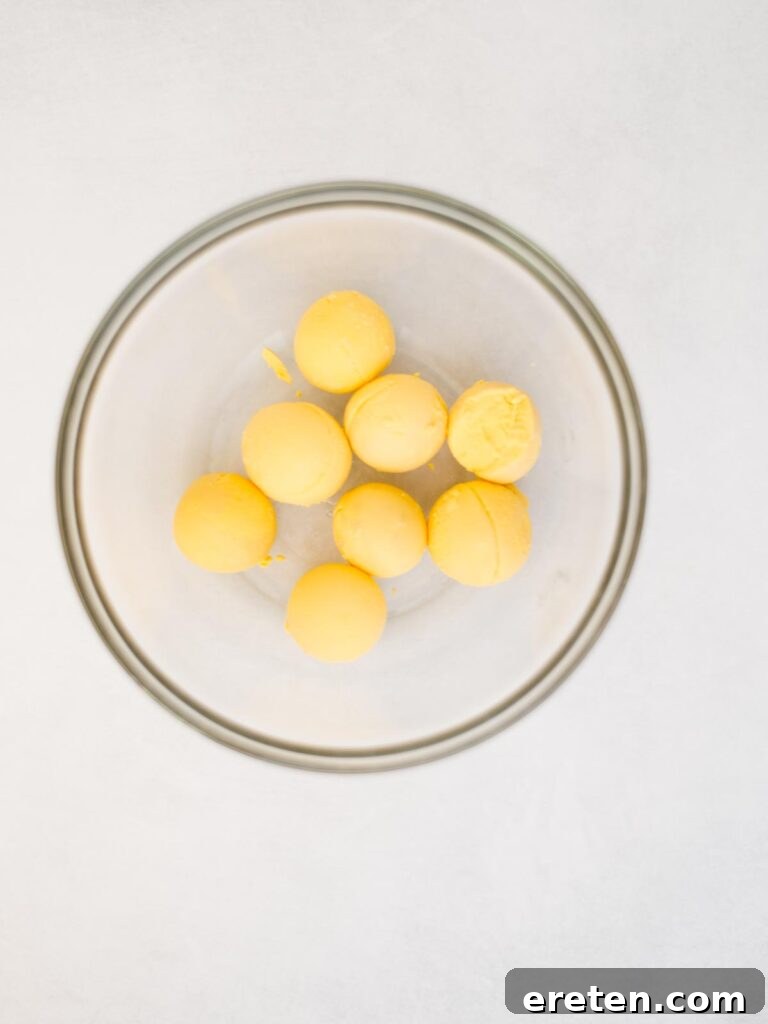 cooked egg yolks added to a mixing bowl.