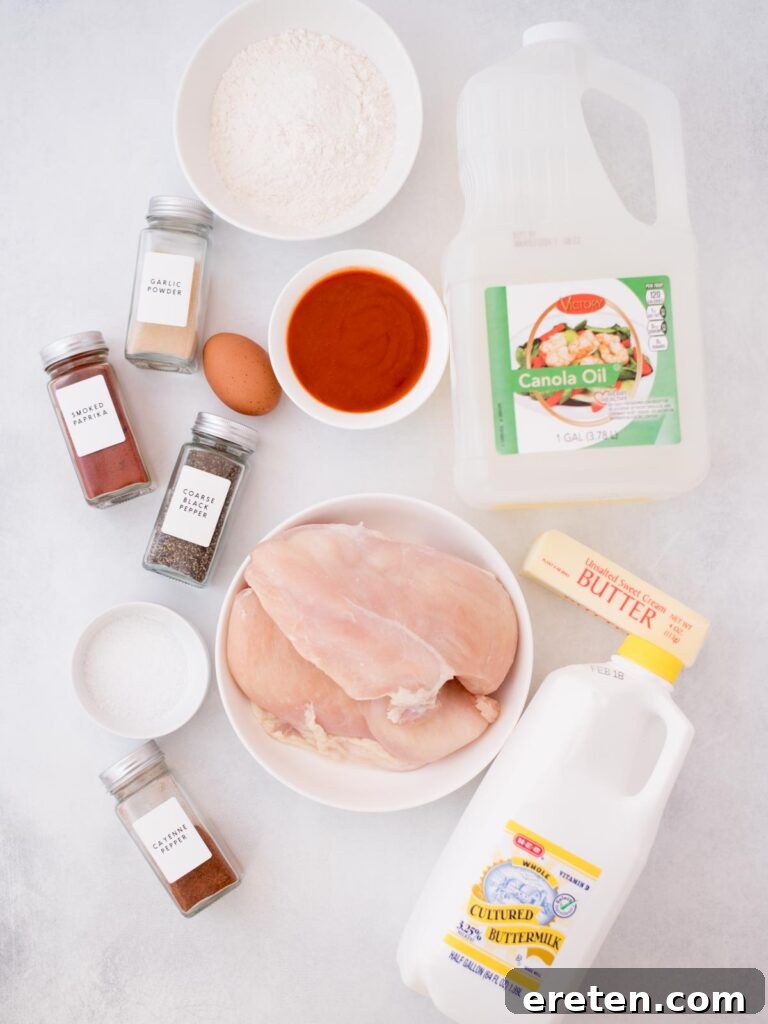 A vibrant flat lay showcasing all the fresh ingredients needed to prepare a batch of delicious homemade boneless wings, including chicken, flour, spices, and buttermilk.