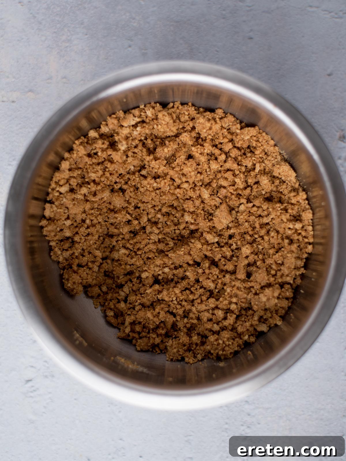 Graham cracker crust ingredients mixed together in a bowl, ready for the melted butter.