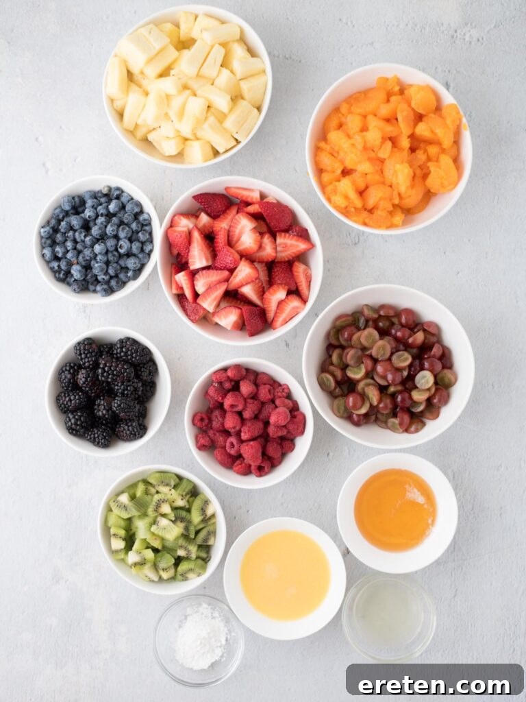 Individual bowls holding various ingredients destined for a vibrant fruit salad, meticulously prepared and ready for assembly, showcasing their fresh colors and textures.