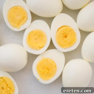 Whole and halved hard-boiled eggs.