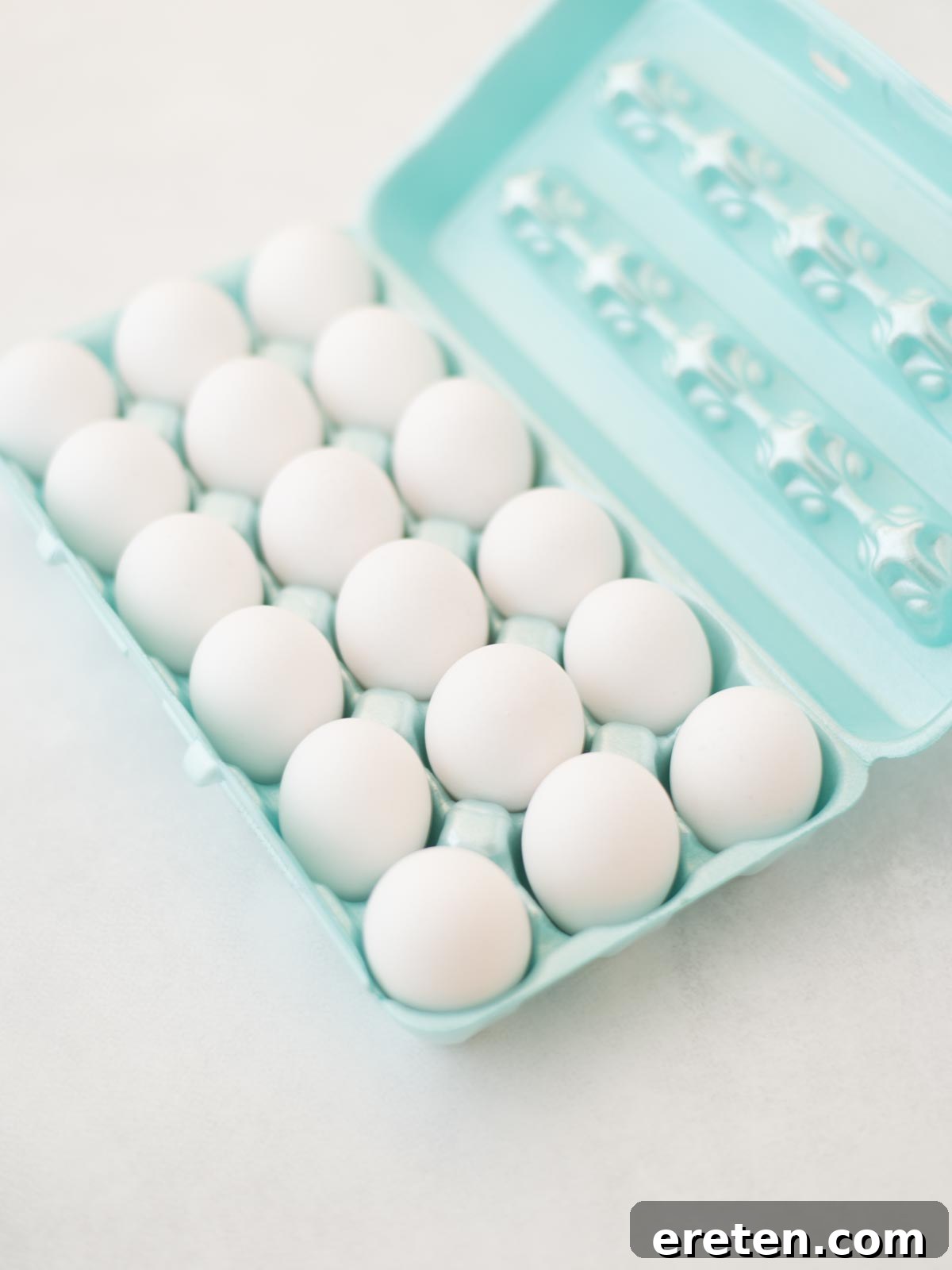 Fresh eggs nestled in an egg carton, ready for boiling.