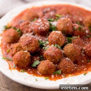 Meatballs in a tomato sauce in a large serving bowl.