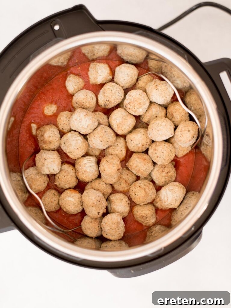 Pressure Cooker Frozen Meatballs 5 Frozen meatballs carefully placed over a trivet, ready to be pressure cooked.