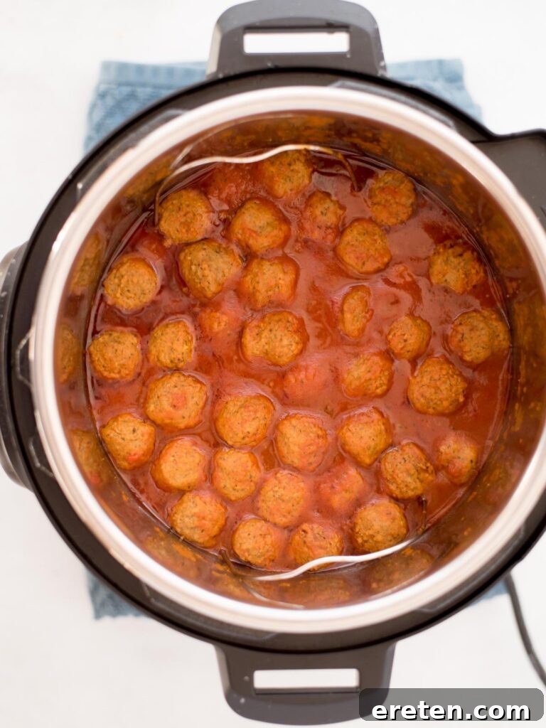 Pressure Cooker Frozen Meatballs 6 Top view of perfectly cooked meatballs simmering in rich tomato sauce within the Instant Pot.