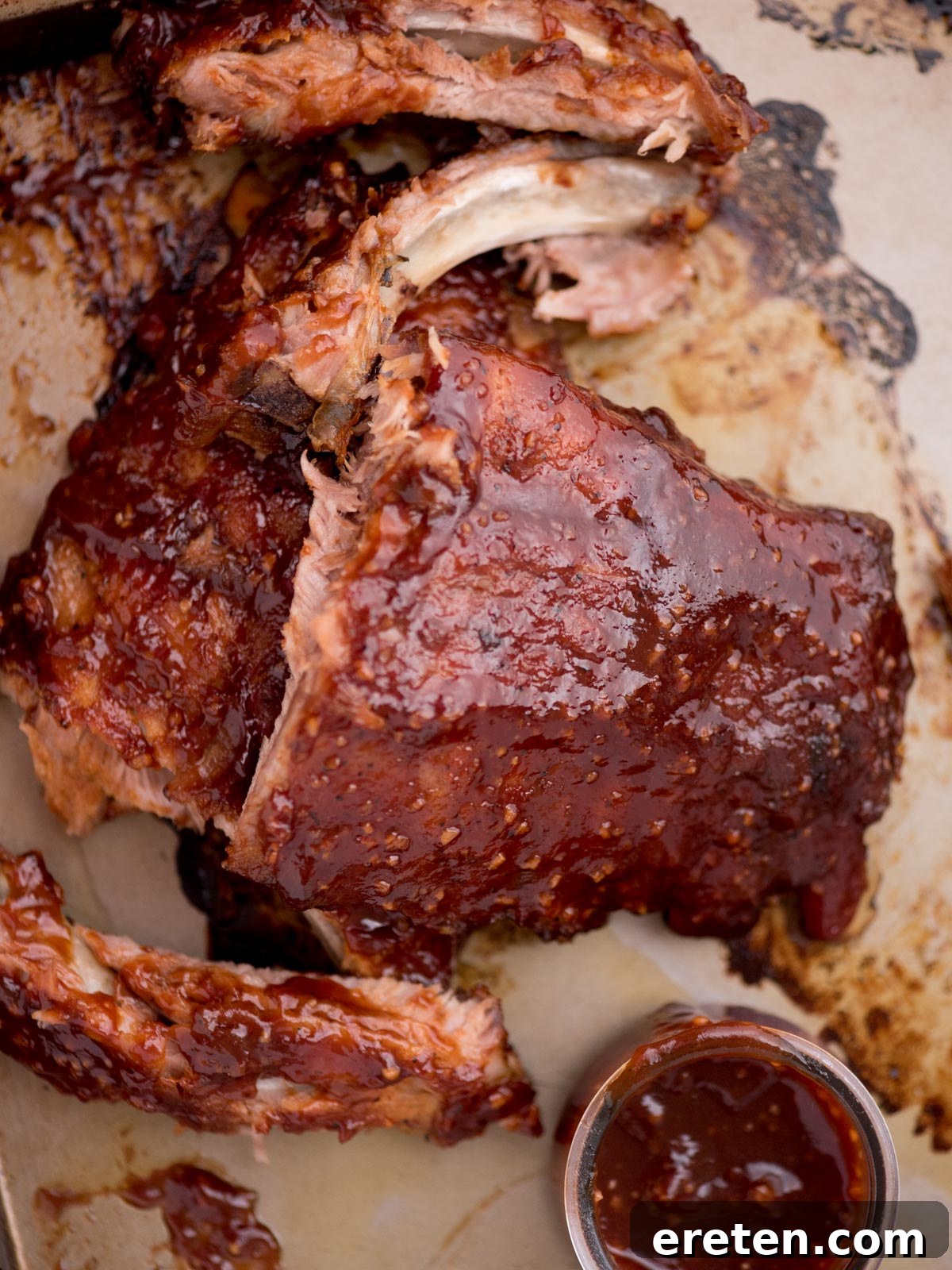 Close-up of perfectly cooked oven-baked ribs, showing the tender meat and caramelized sauce.