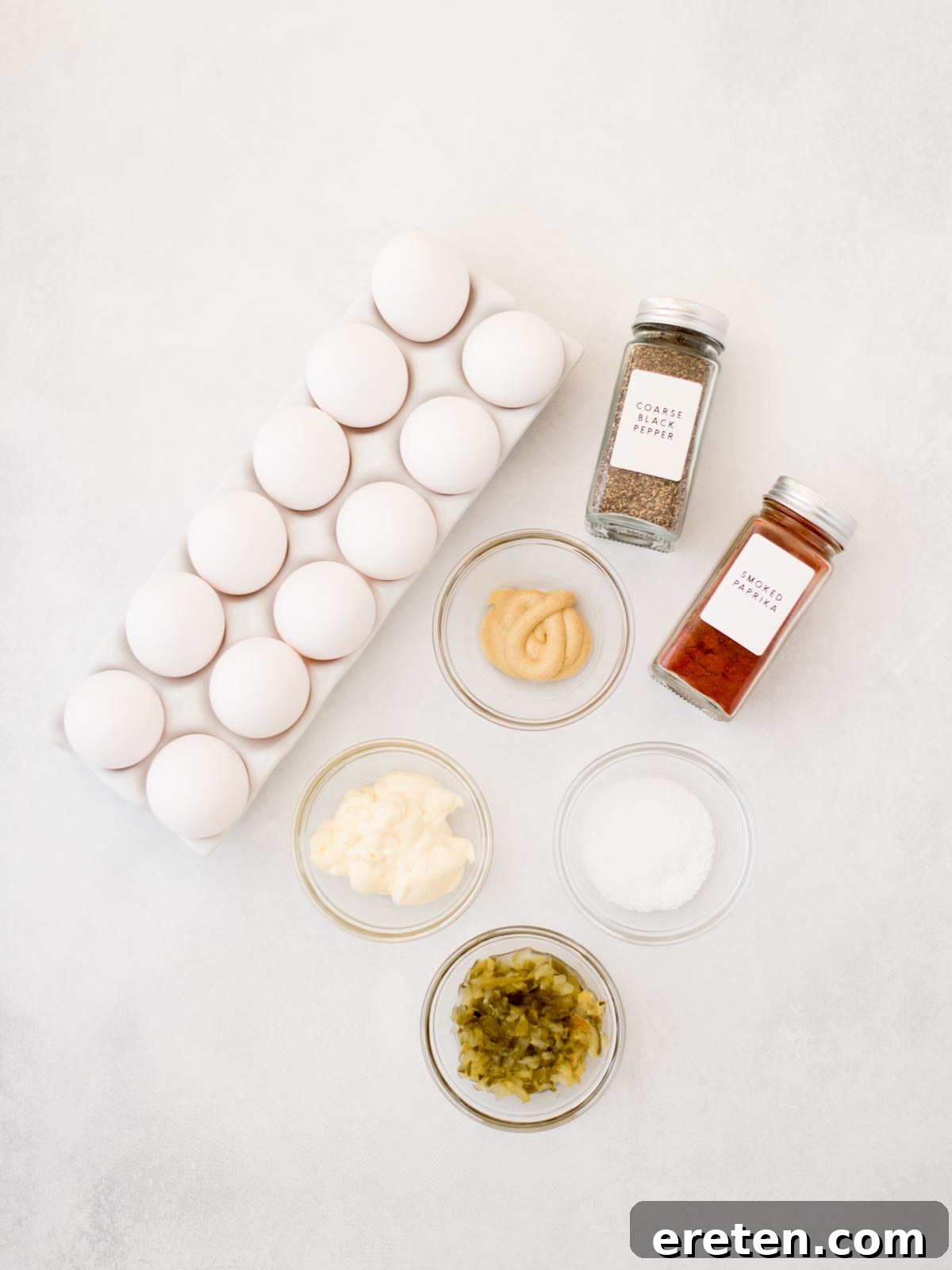 Close-up of fresh ingredients for deviled eggs, including eggs, mustard, mayonnaise, and relish.