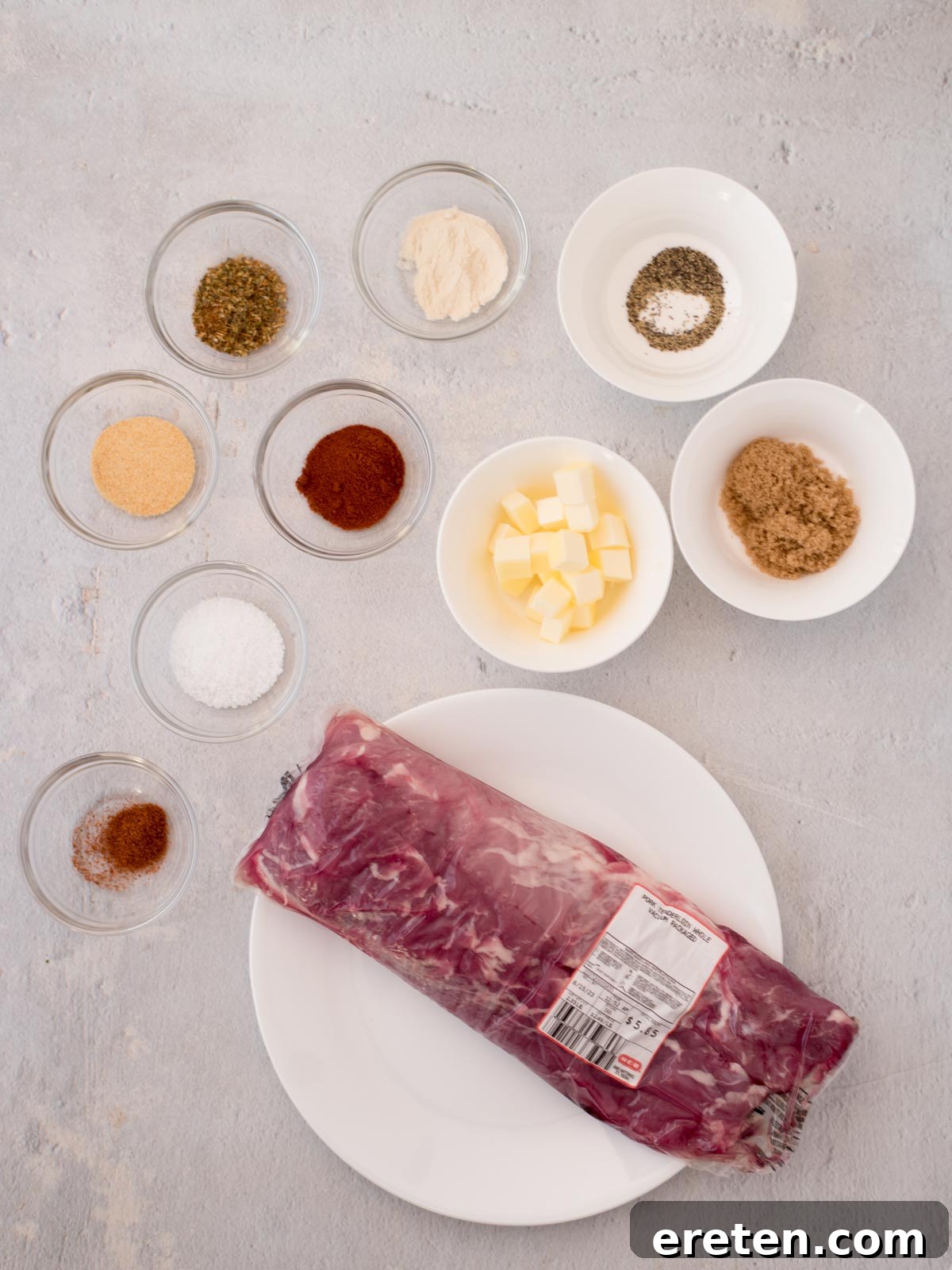 A collection of fresh ingredients neatly arranged on a counter, showcasing everything needed to prepare this delicious pork tenderloin recipe.