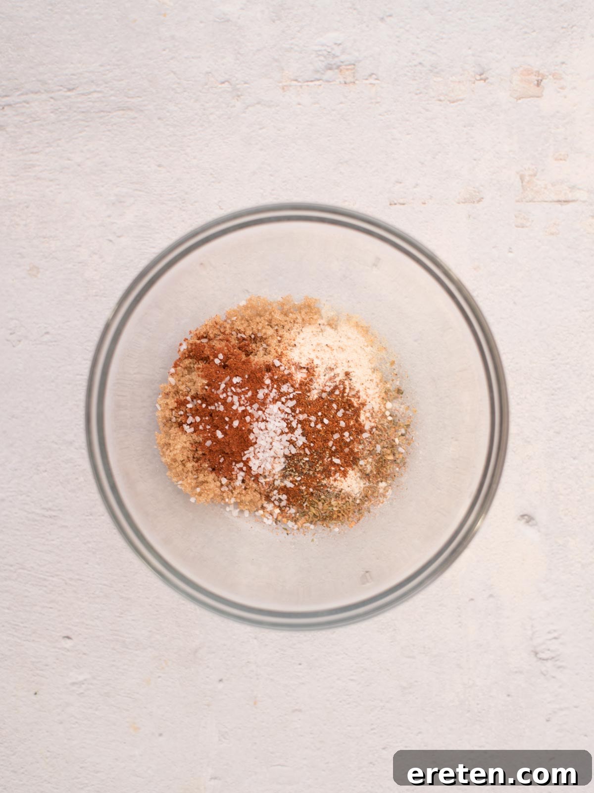 All the dry seasonings for the pork tenderloin recipe are combined in a small glass mixing bowl, ready to be stirred.