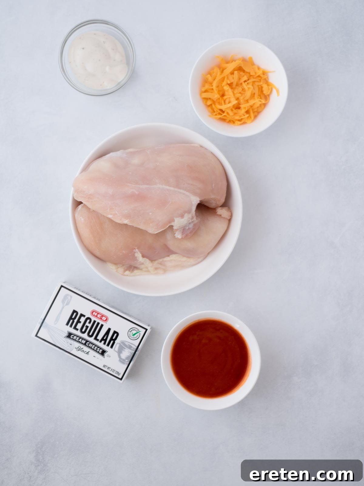 Ingredients shown are used to prepare Instant Pot Buffalo Chicken Dip.