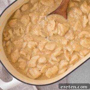 Chicken and dumplings using canned biscuits is cooked and ready to serve in a baking dish.