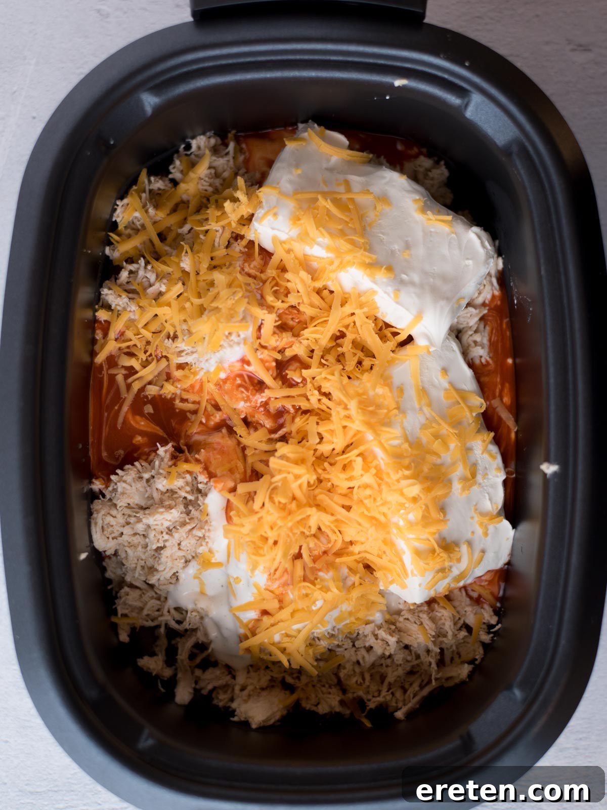 ingredients for crockpot buffalo chicken dip in a slow cooker