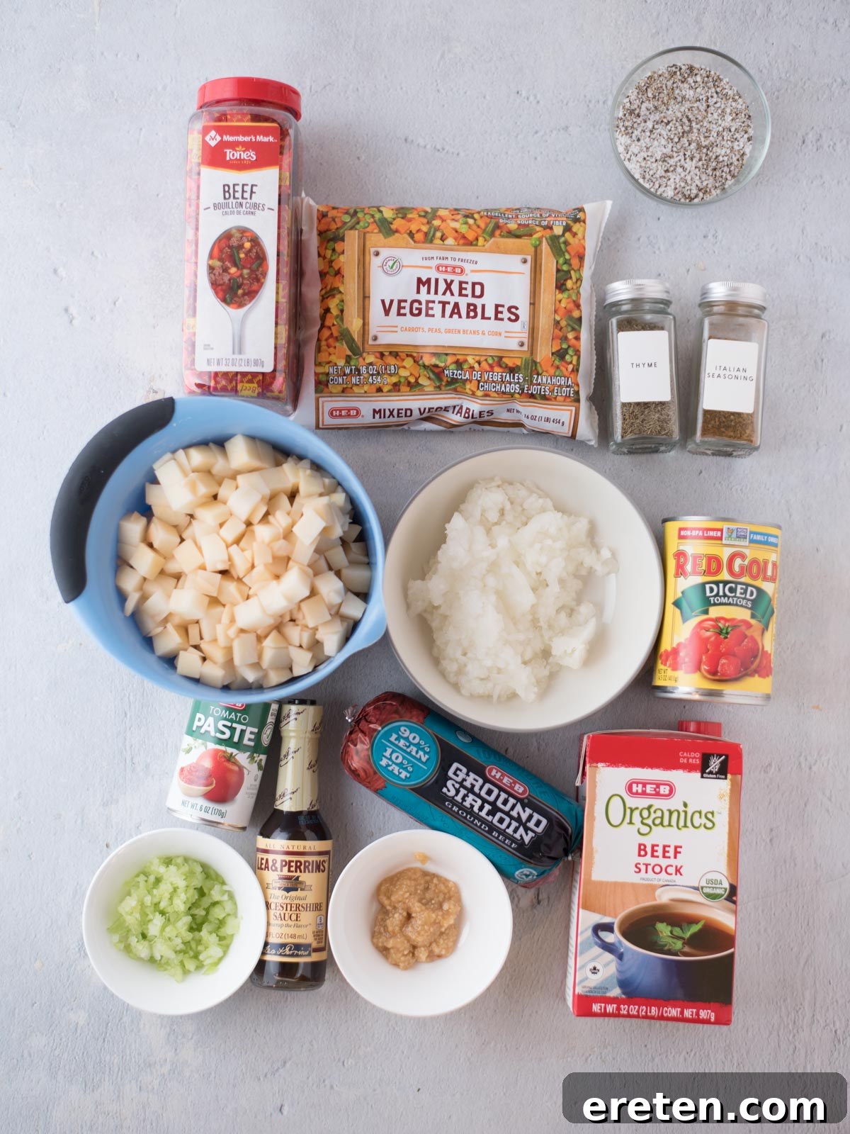 Hearty Hamburger Vegetable Soup 3 A vibrant flat lay of all the fresh and canned ingredients meticulously arranged on a countertop, ready to be transformed into a delicious homemade hamburger soup.