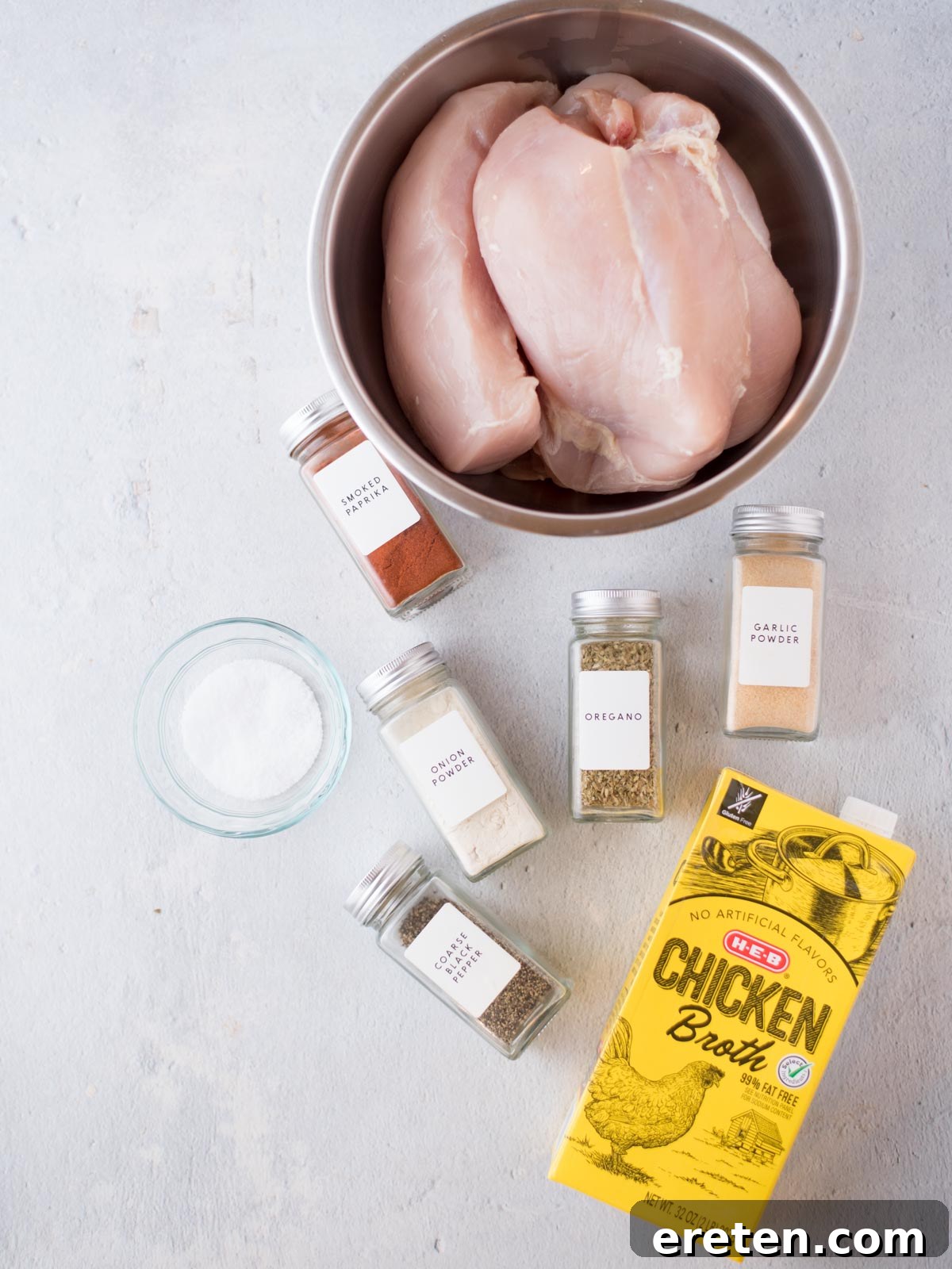 Easy Instant Pot Shredded Chicken 3 Instant Pot filled with raw chicken breasts seasoned with spices and chicken stock.