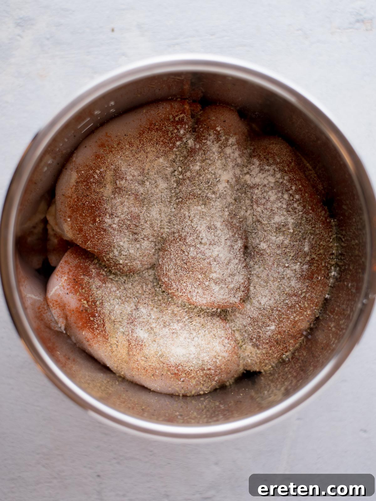 Easy Instant Pot Shredded Chicken 4 Chicken breasts seasoned in the Instant Pot before cooking.