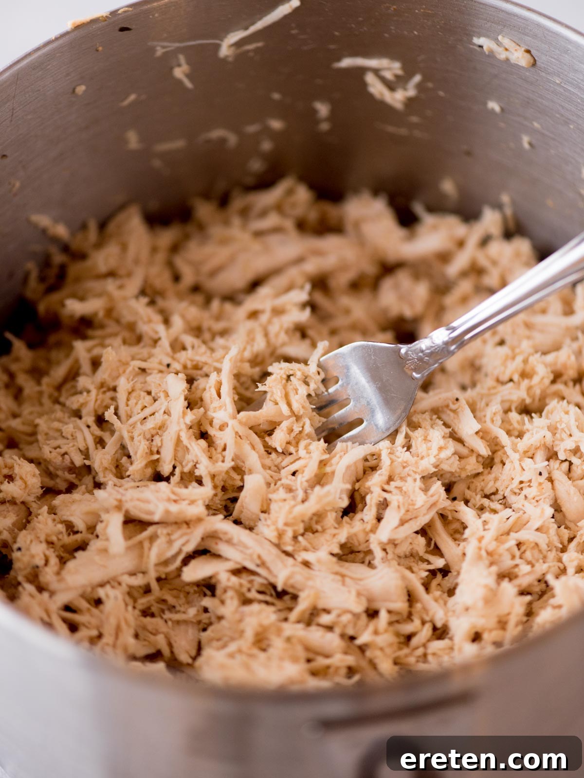 Easy Instant Pot Shredded Chicken 7 Large batch of shredded chicken stored in an airtight container for meal prep.