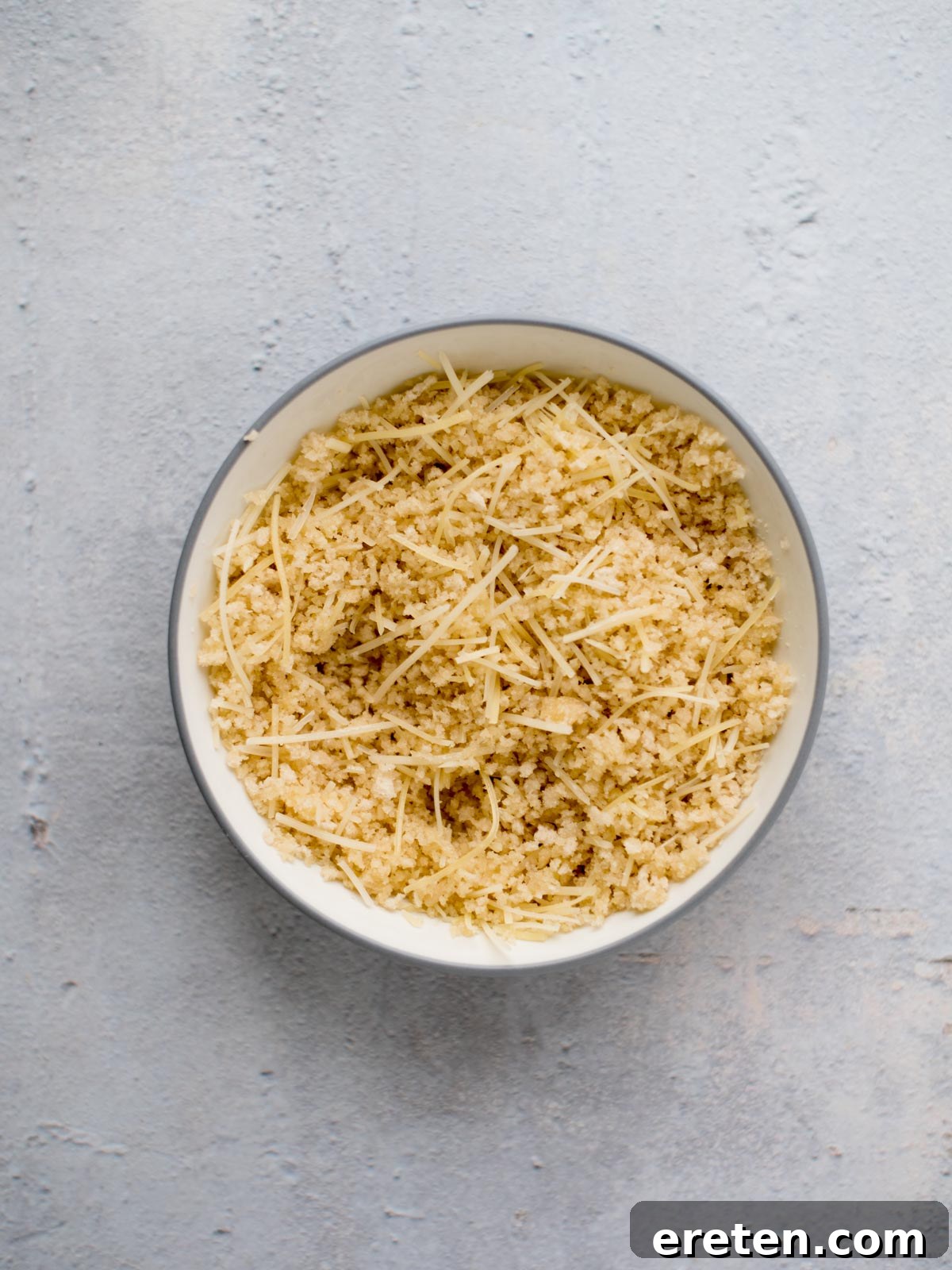 melted butter, breadcrumbs, and parmesan mixed together in a bowl