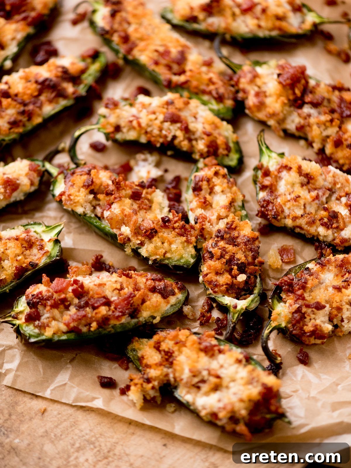 Air fryer jalapeno poppers served on parchment paper on a wooden board
