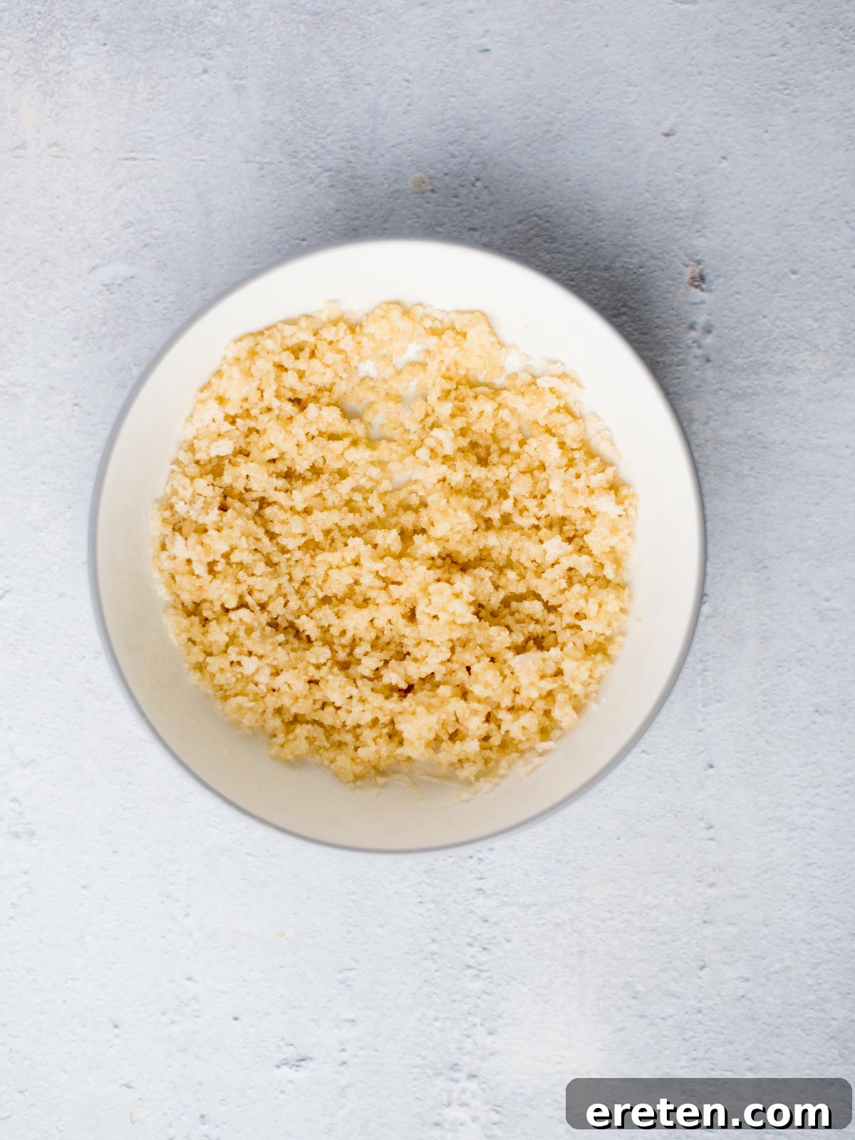 Panko breadcrumbs mixed with melted butter in a small bowl