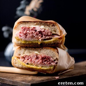 stacked cuban sandwiches on a bread board