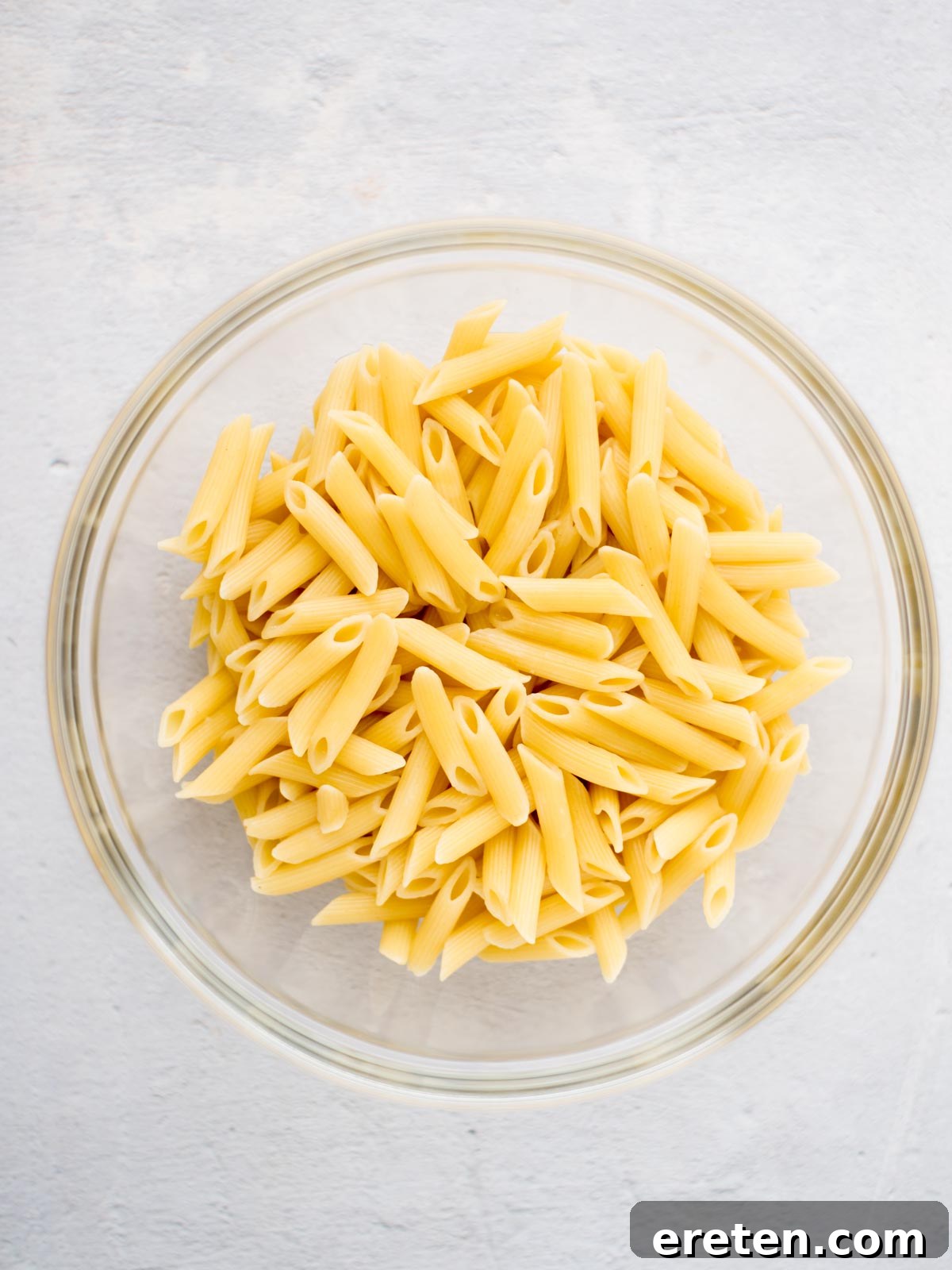 Cooked pasta in a mixing bowl.