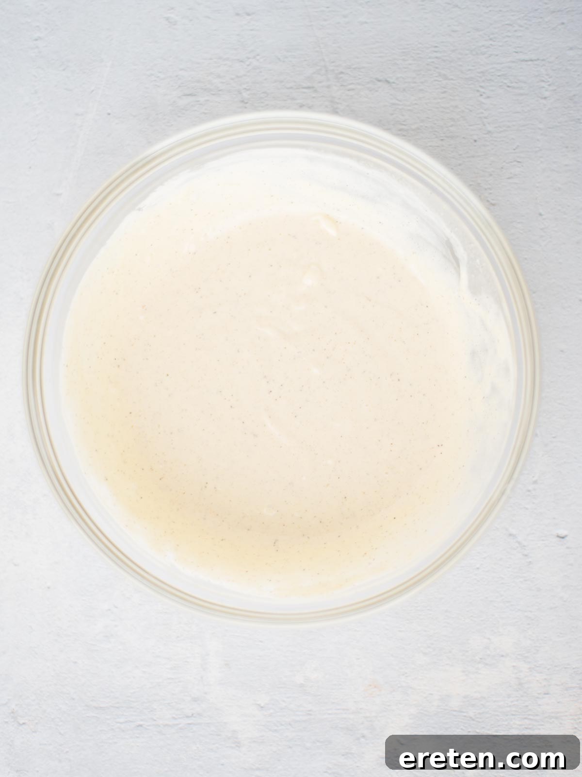 Grandma's Heirloom Macaroni Salad 4 Dressing for macaroni salad in a glass mixing bowl.