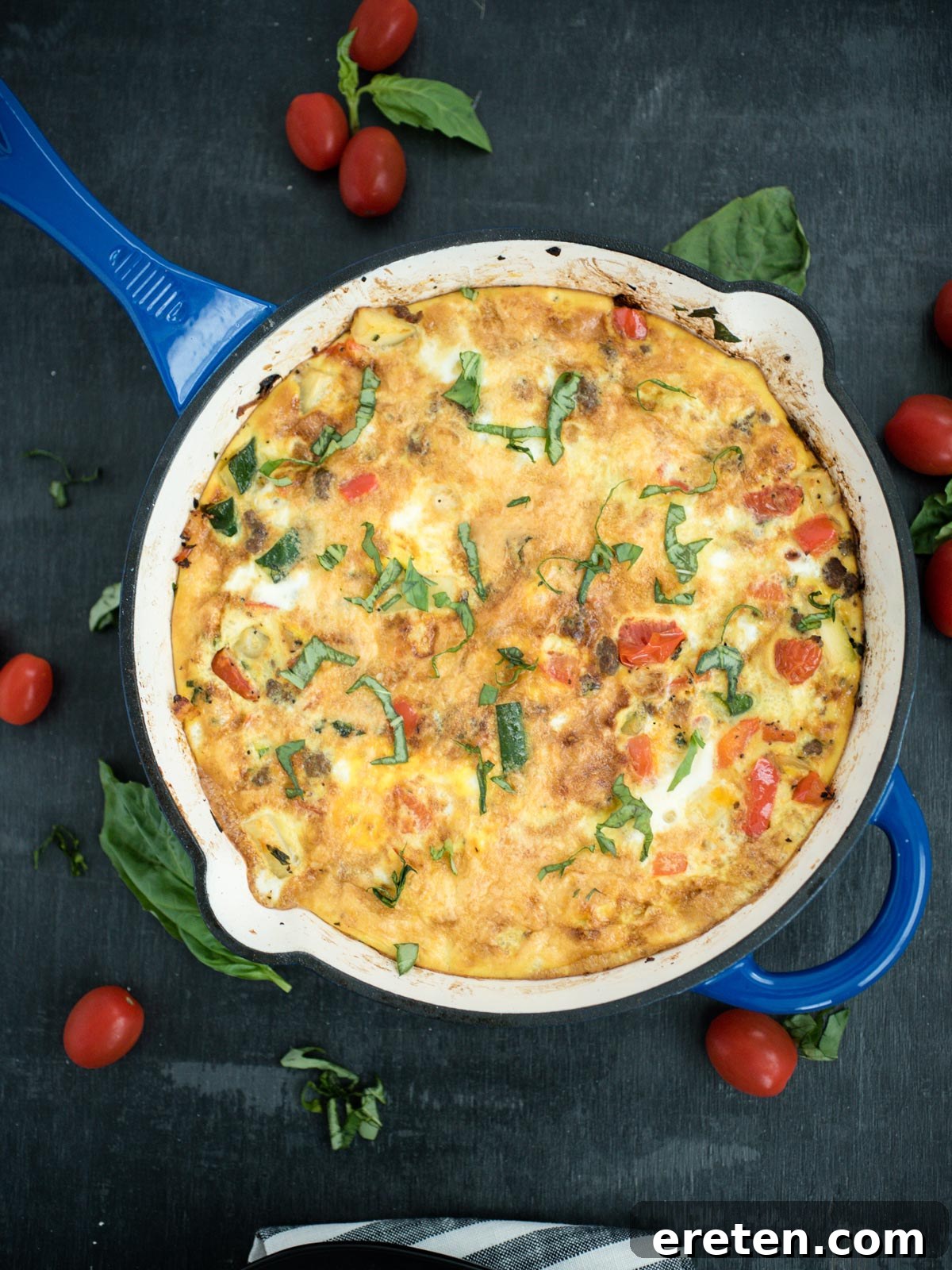 Delicious Veggie, Turkey Sausage, and Basil Frittata in a cast iron enamel pan