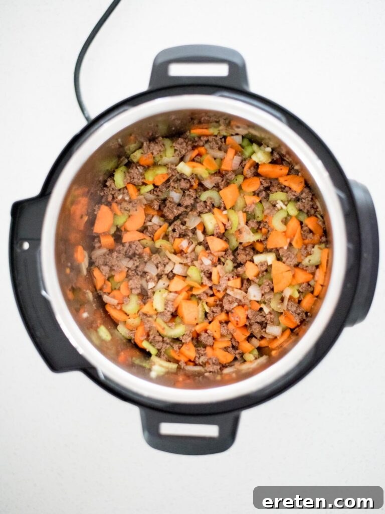 Hearty Instant Pot Spaghetti with Savory Meat Sauce 4 How to make Instant Pot spaghetti by sautéing vegetables and meat together