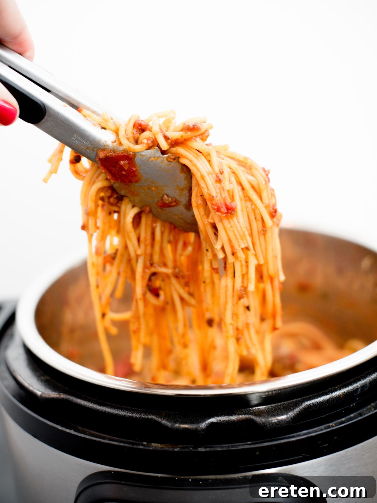Hearty Instant Pot Spaghetti with Savory Meat Sauce 9 Spaghetti being pulled from Instant Pot with tongs