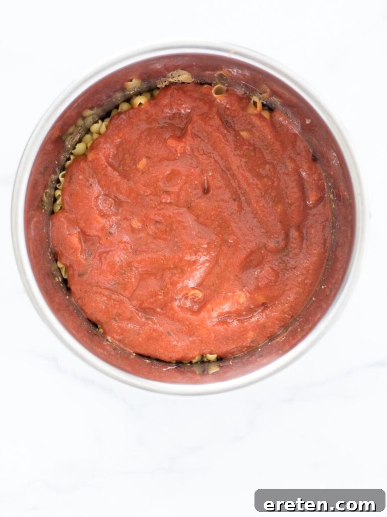 Homemade Instant Pot Cheeseburger Mac 7 pasta sauce poured into instant pot