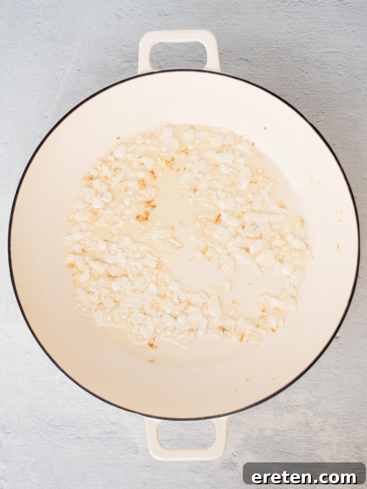 Oil and onion in a skillet sauteing