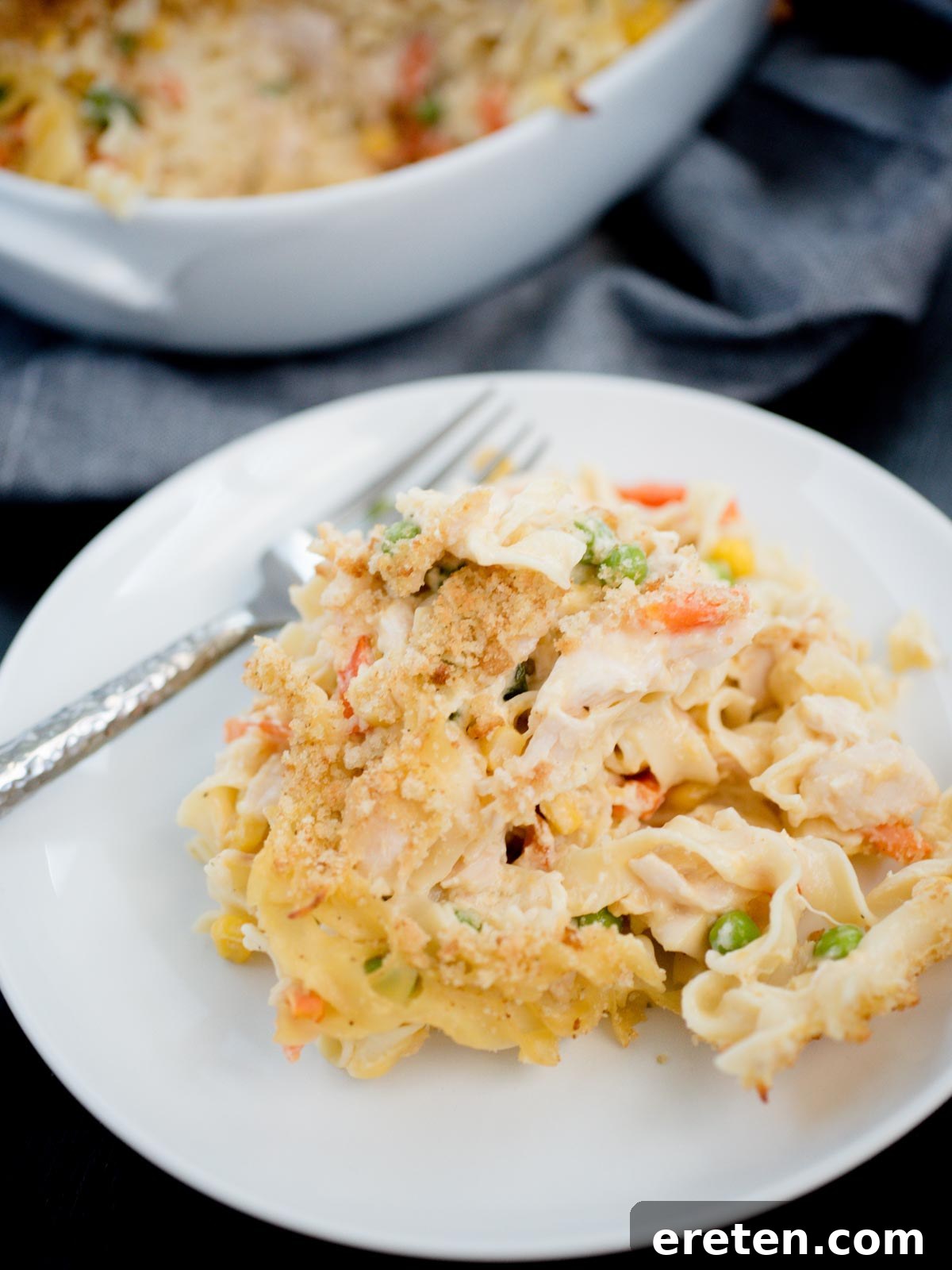 Creamy Chicken Noodle Pot Pie Casserole 2 serving of chicken noodle casserole on white plate, ready to be enjoyed