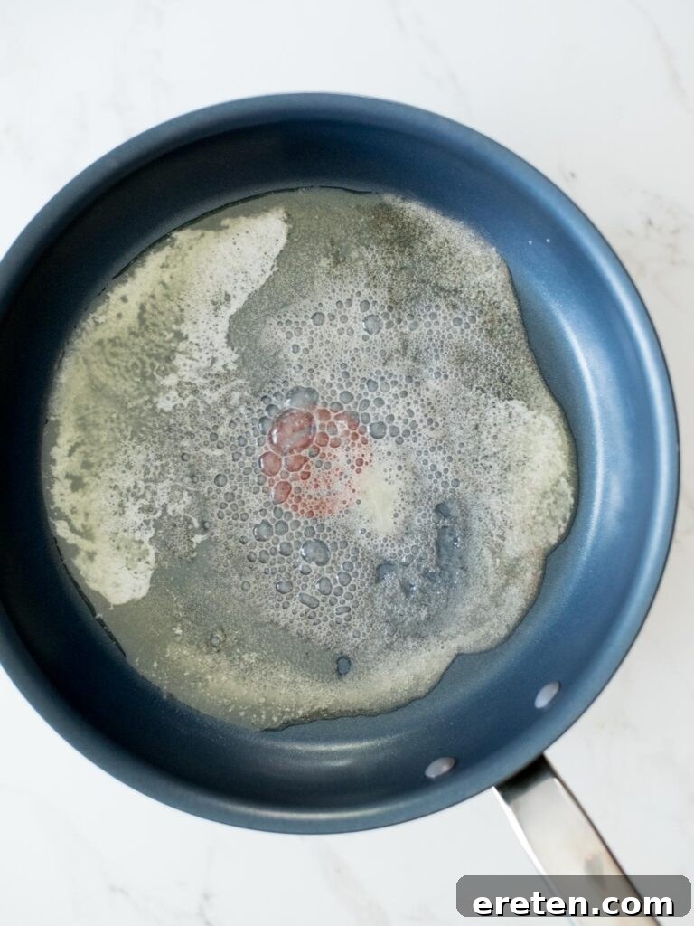 Pan-Seared Butternut Squash Delight 5 Fully melted butter creating a pool at the bottom of a skillet.