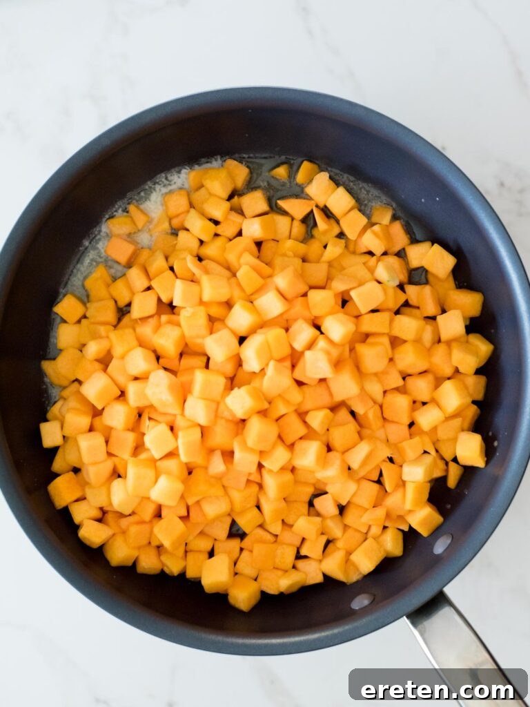 Pan-Seared Butternut Squash Delight 6 Cubed butternut squash added to a skillet with melted butter.